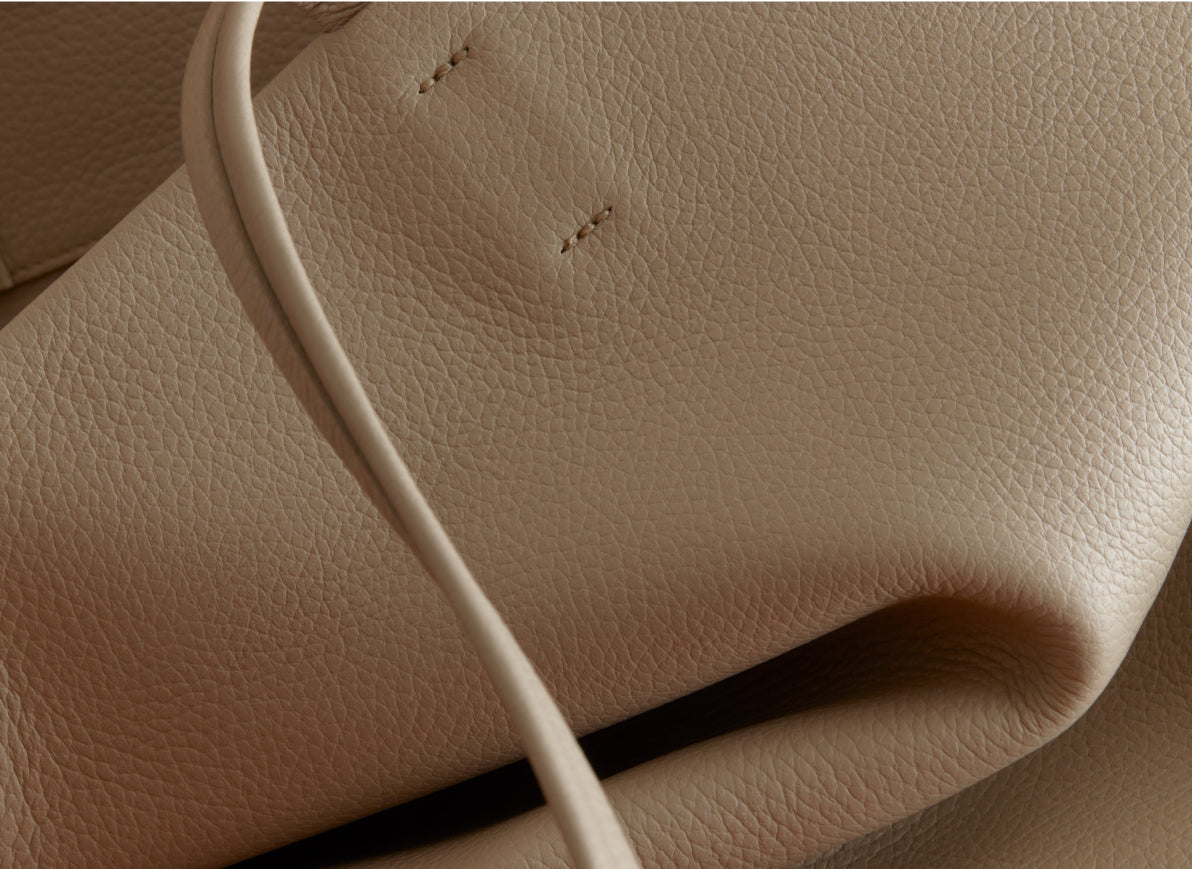 Close-up of a textured leather surface with a strap.