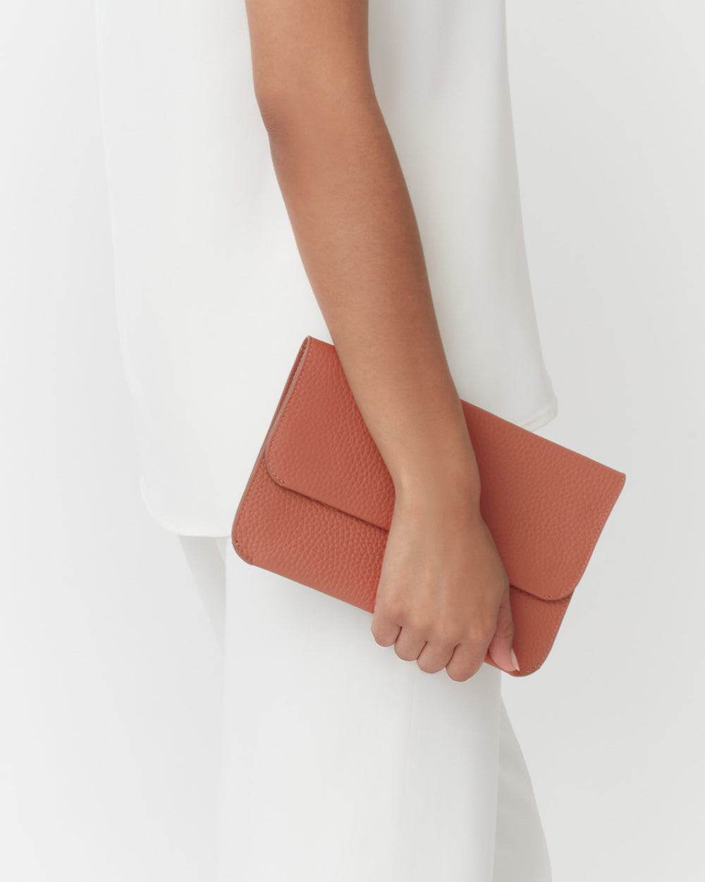 Person holding a clutch bag