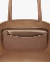 Close-up of a handbag with a zipper pocket.