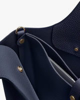 Close-up view of an open handbag with visible interior pockets.