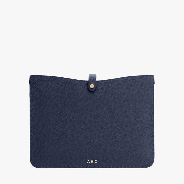 Flat pouch with a snap closure and personalized initials.