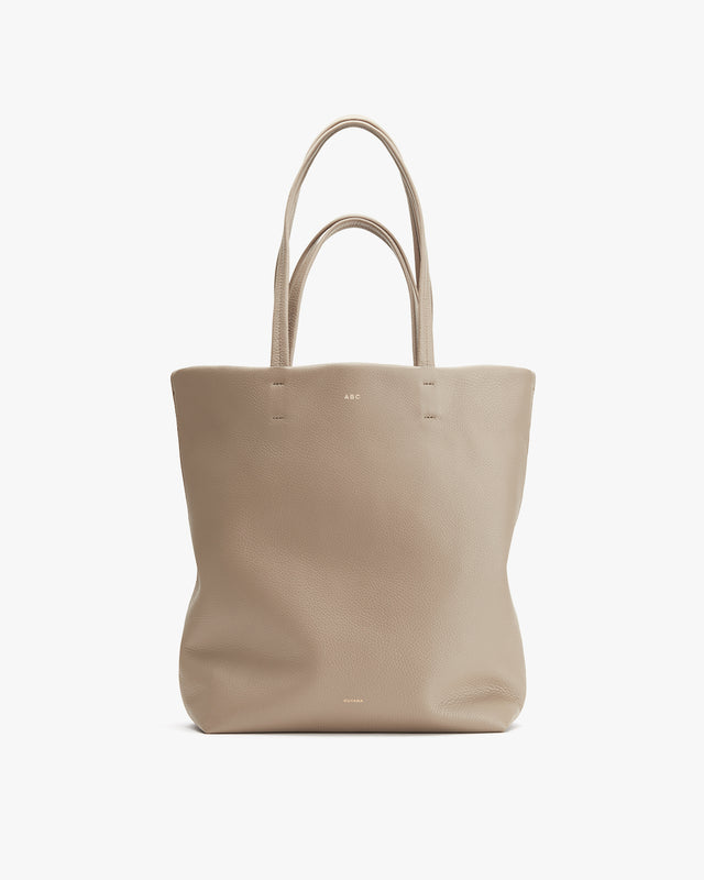 Plain tote bag with two handles standing upright.