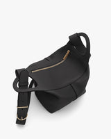 Handbag with a strap and zipper pocket