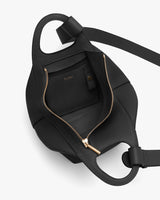 Open handbag with a visible inner pocket, zipper, and shoulder strap
