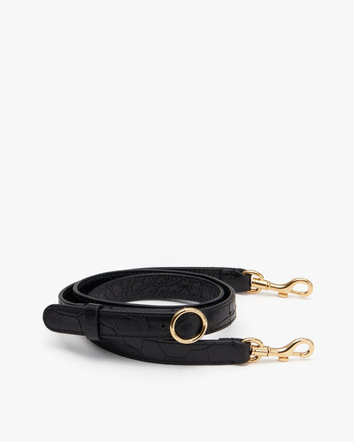 Handbag strap with clasps and a circular detail.