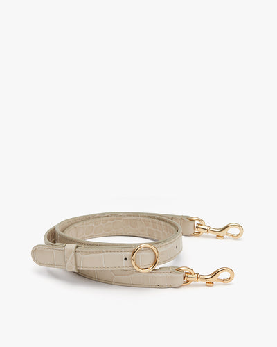 Handbag strap with metal clasps and a circular ring