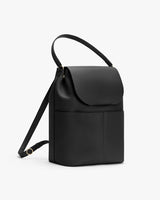 Handbag with a flap cover and shoulder strap.