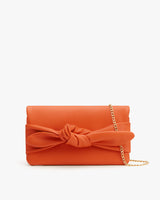 Clutch with a bow detail and a chain strap.