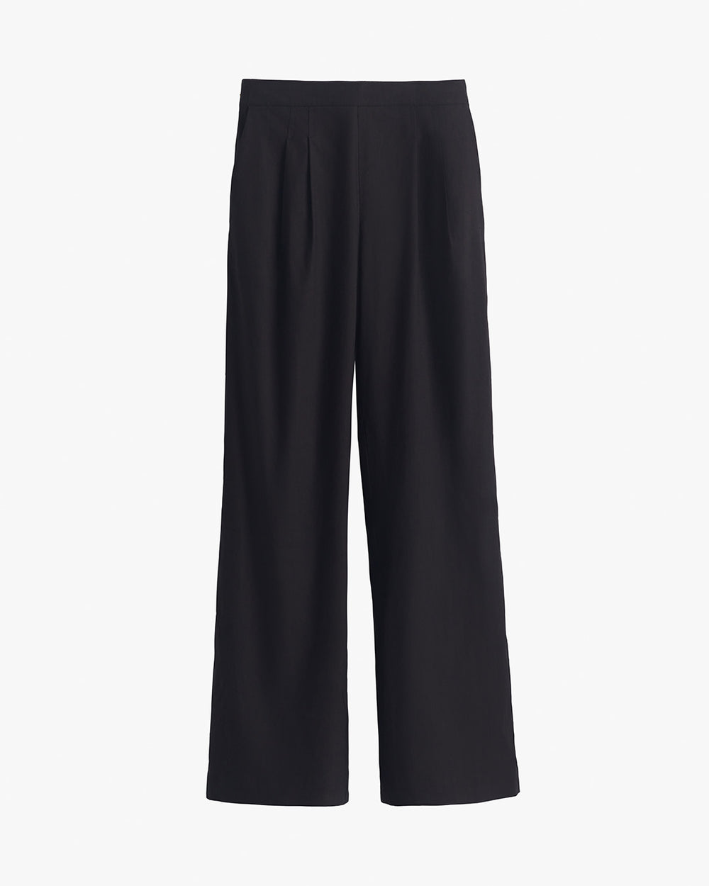 Pair of wide leg pants hanging against a plain background