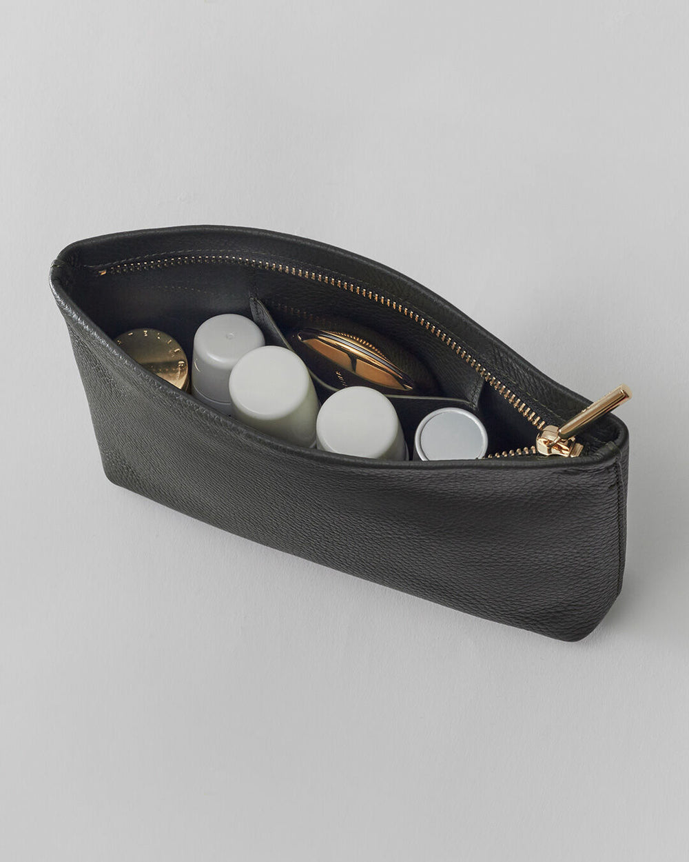 Open pouch with various small items inside.