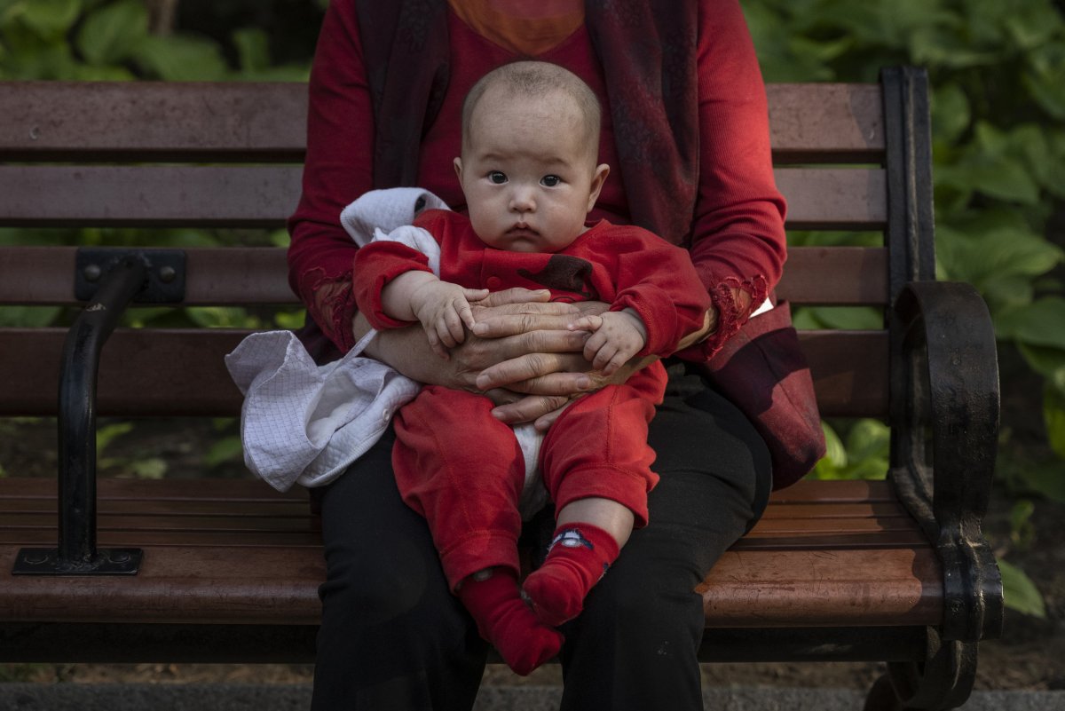 Woman Holds Baby in Beijing Park