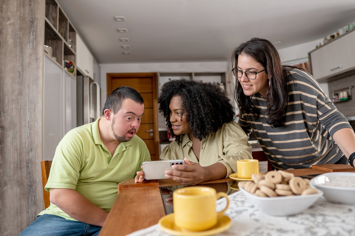 Enhance Customer Experience_family looking at phone over breakfast
