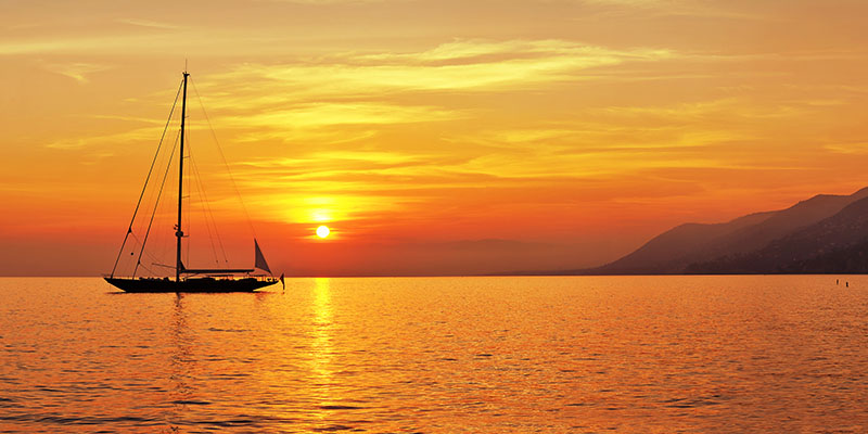 Panoramic view of Sailing at sunset with mountains