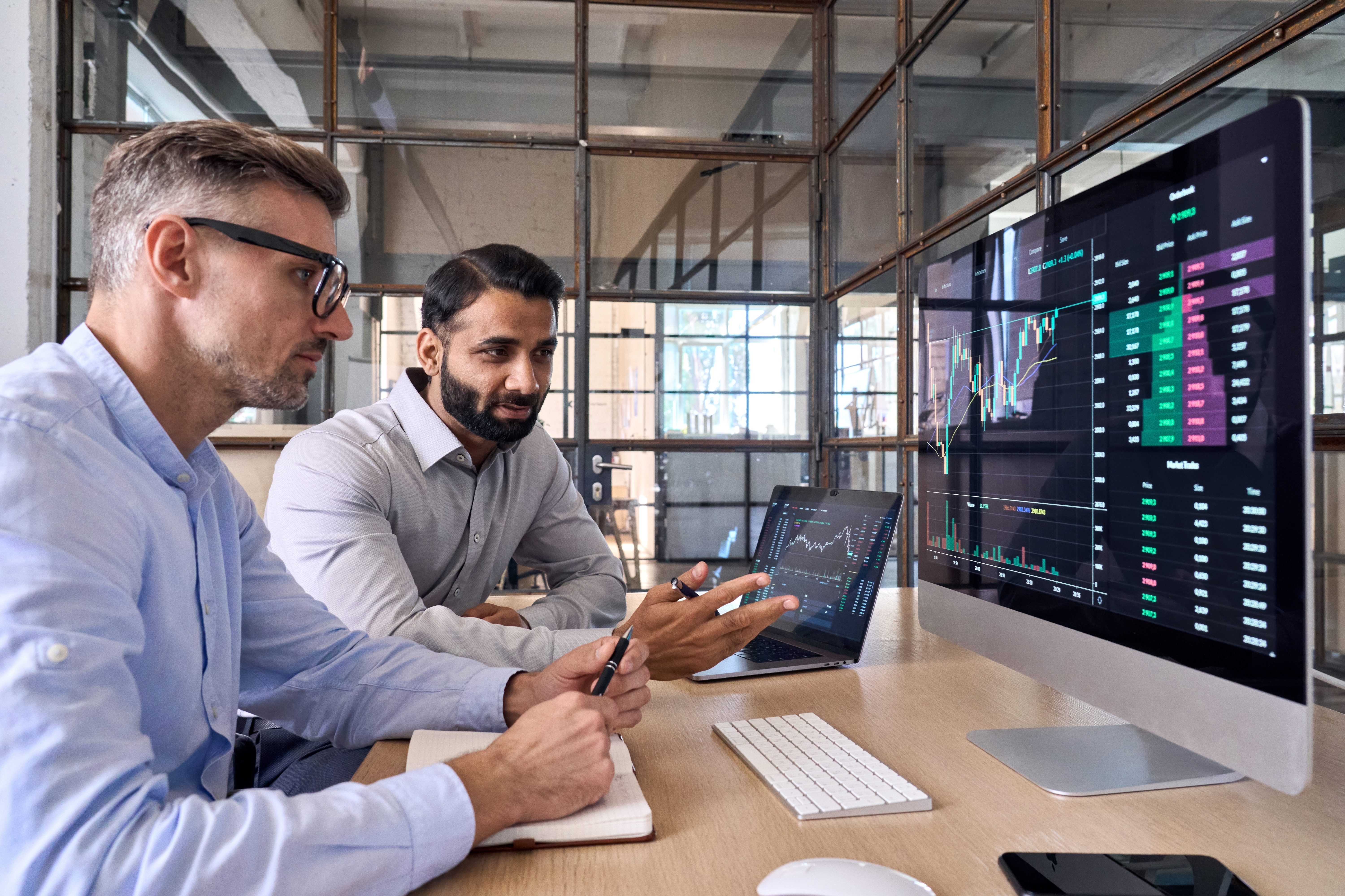 Two people looking at a laptop