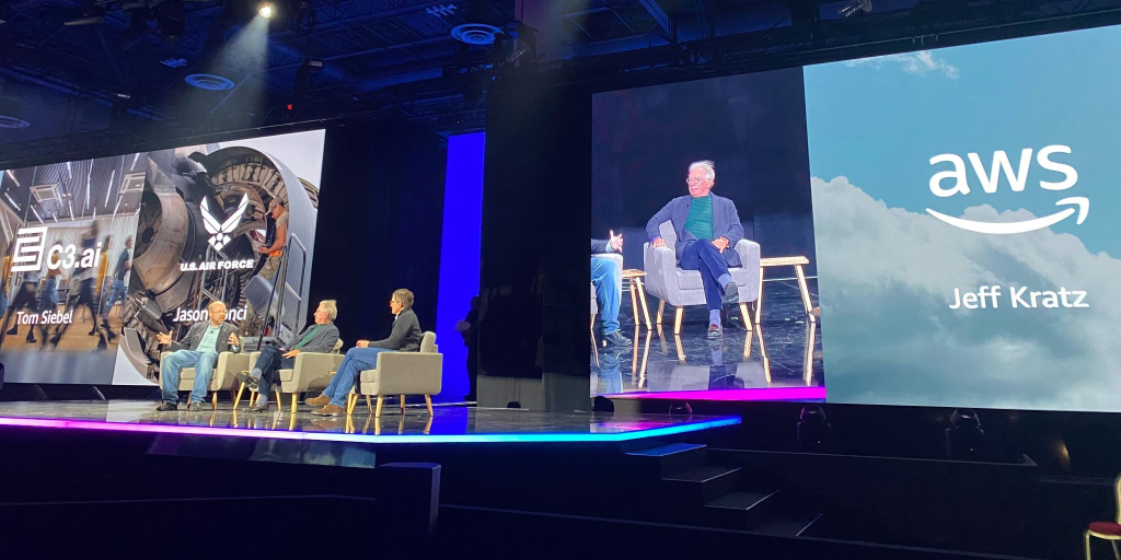 photo showing the fireside chat that took place between, seated from left to right, Jason Bonci, Thomas Siebel, and Jeff Kratz