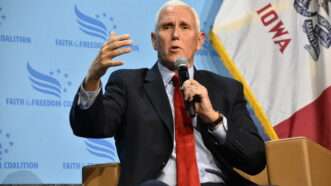 Former Vice President Mike Pence speaks into a handheld microphone in front of a "Faith and Freedom" backdrop. | Kyle Mazza/ZUMAPRESS/Newscom