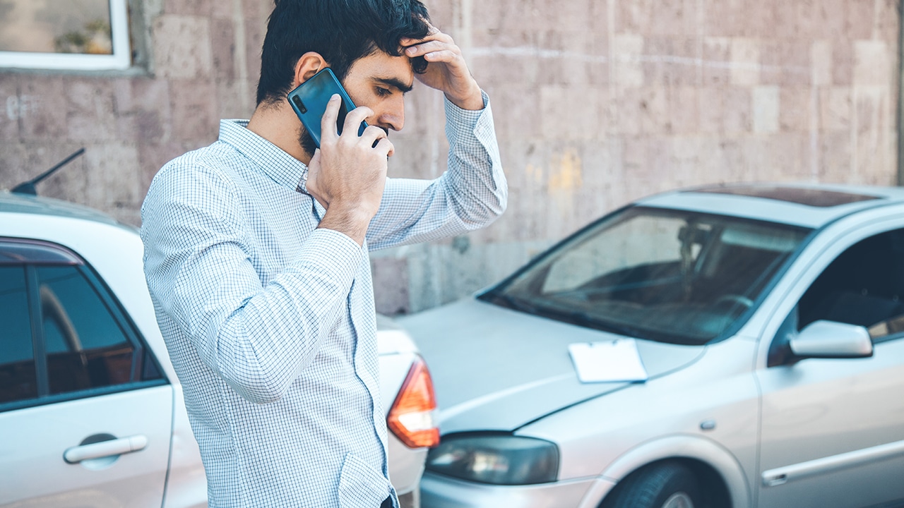 Man calling first aid after car crash accident