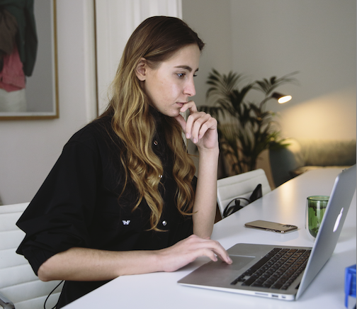 woman looking at laptop at online divorce reviews