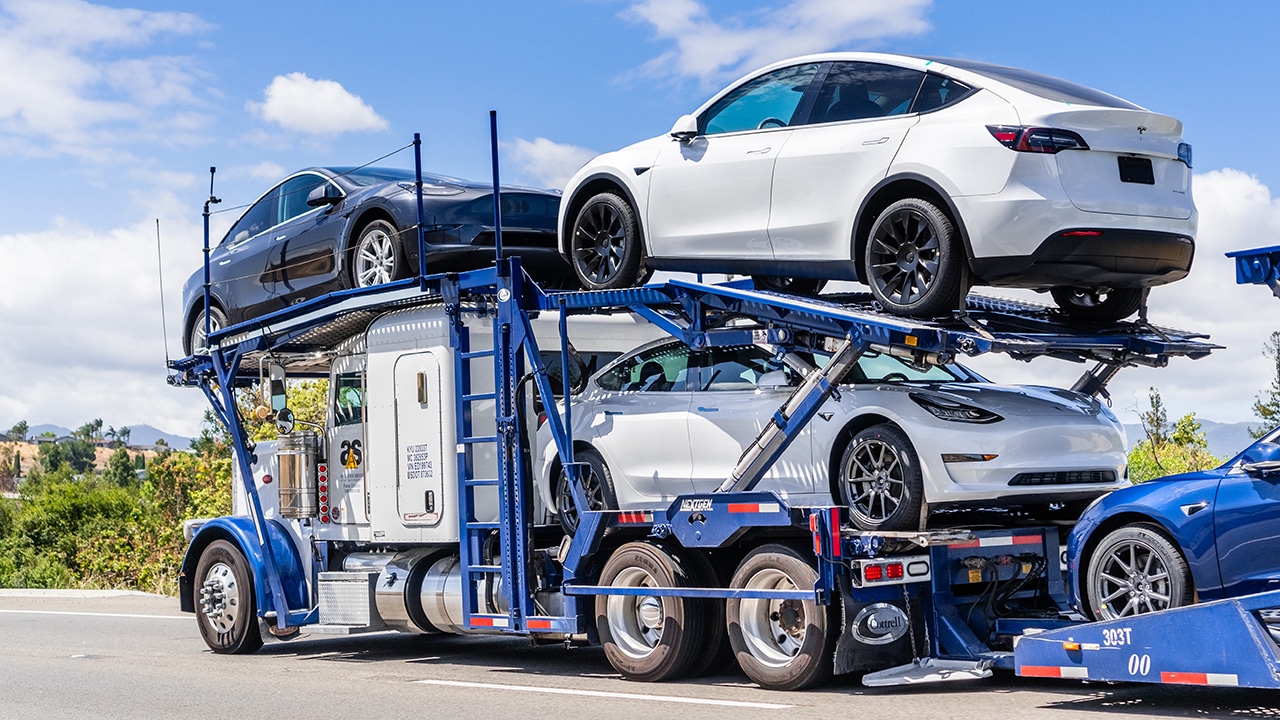 Car transporter carries new vehicles