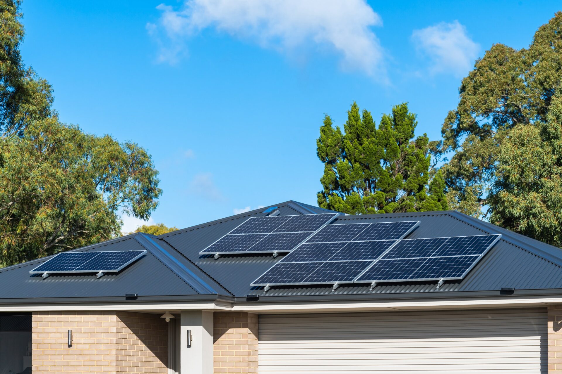 New solar panels installed on metal sheet roof of a house