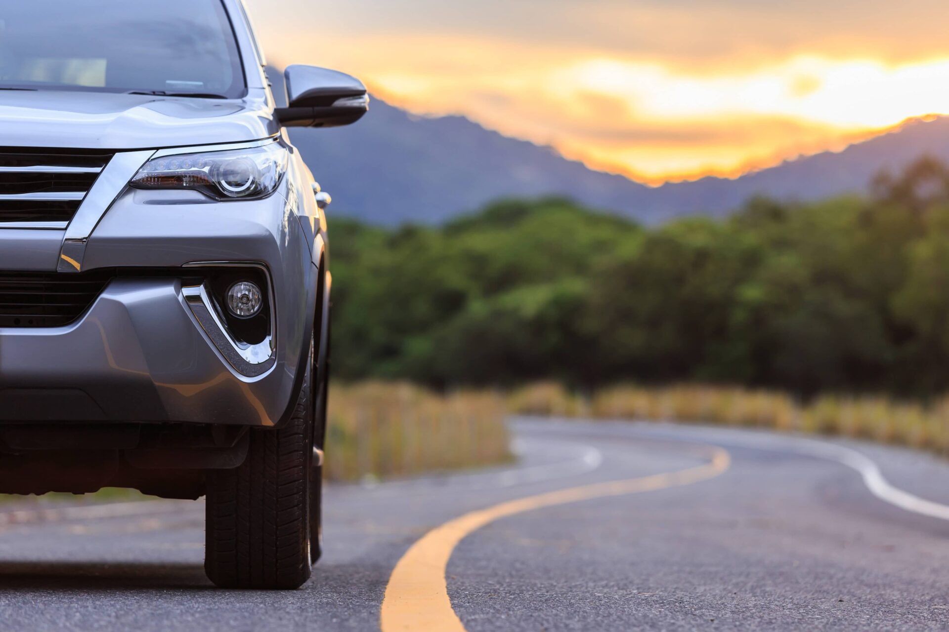 A silver SUV on a winding road