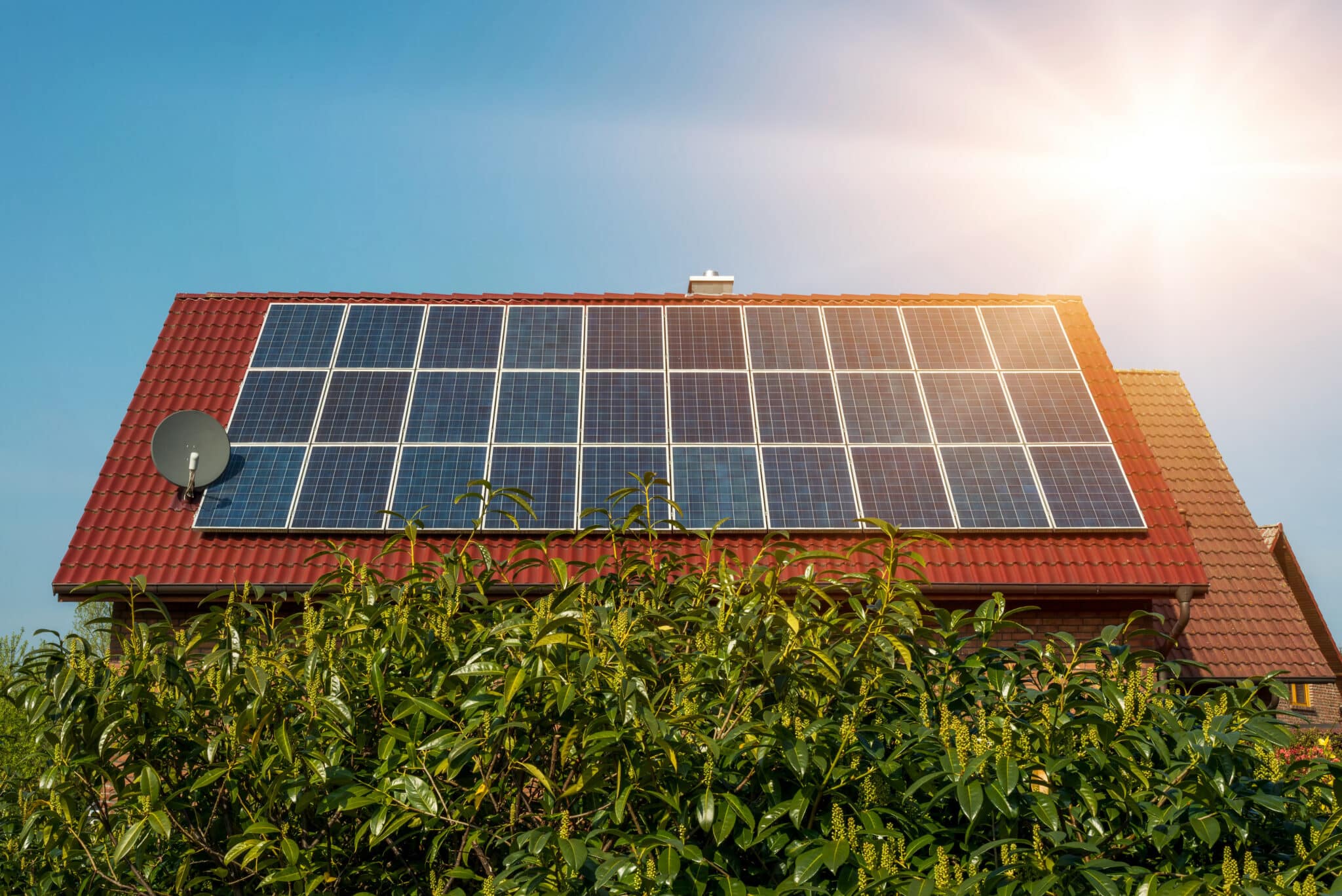 Solar panel on a red roof - renewable alternative energy source