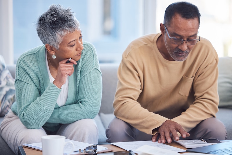 black older couple discusses medical alert systems covered by insurance