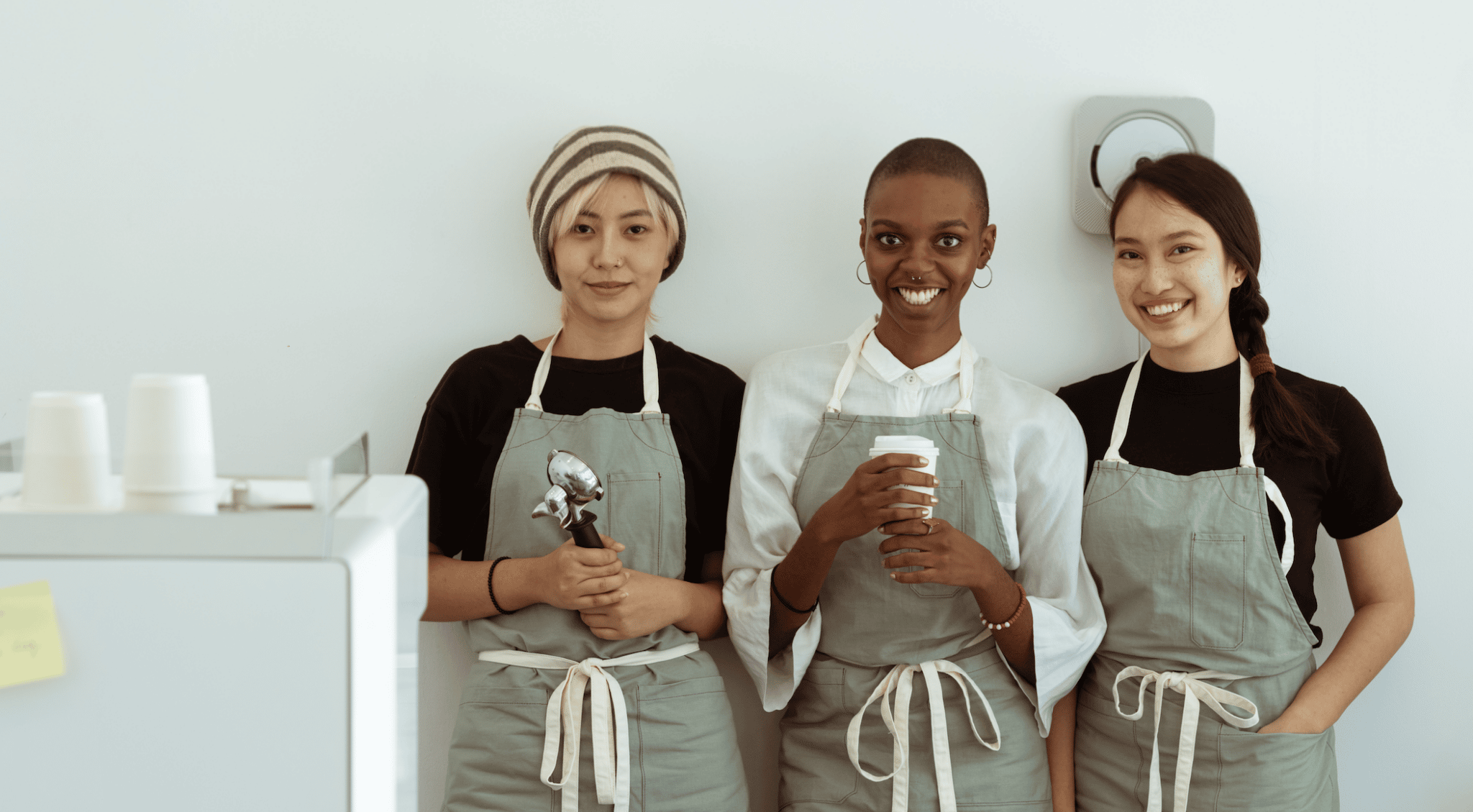 three-business-women-standing-together-in-coffee-shop