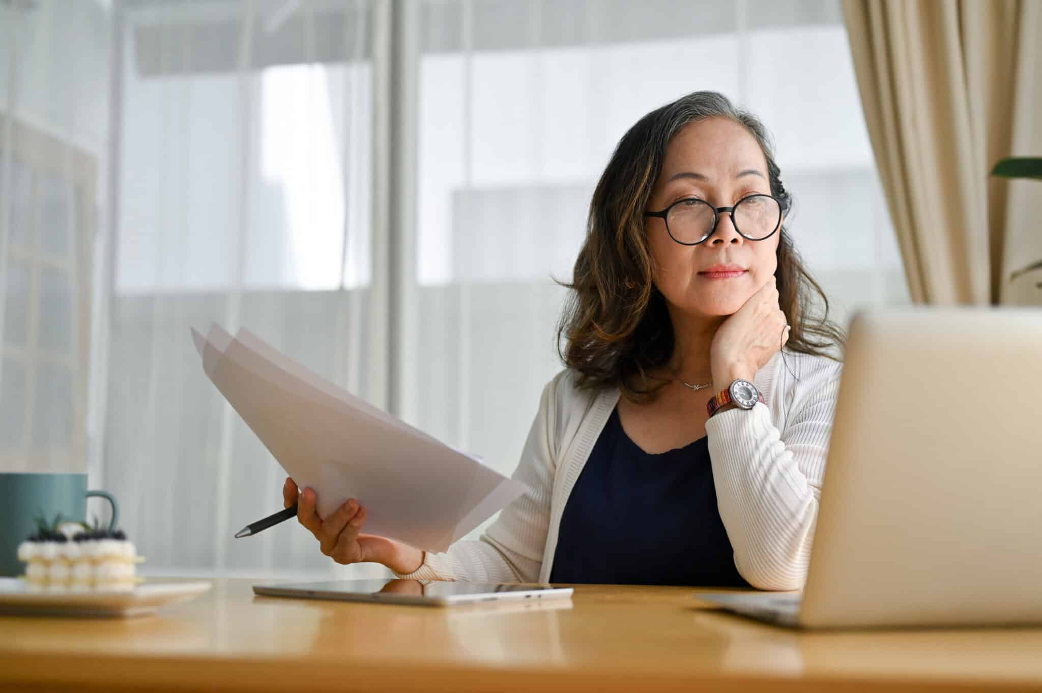 Woman researching how to create an operating agreement on laptop