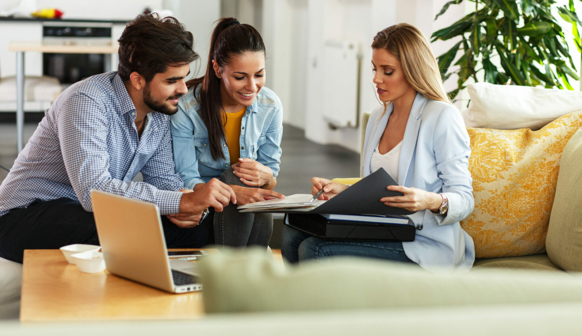 life insurance agent selling policy to young couple