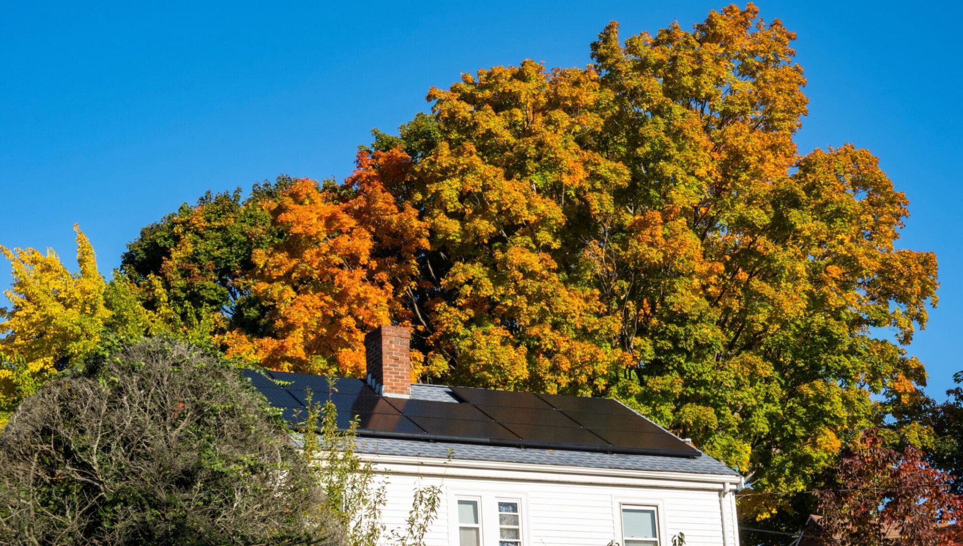 House with solar panels on the roof in autumn, Water Town, Massachusetts, USA