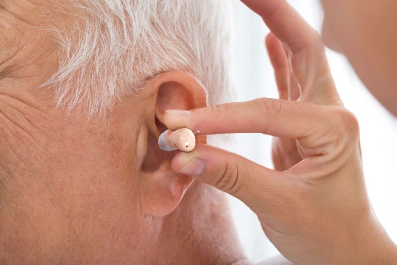 Audien ITE hearing aid being inserted into ear