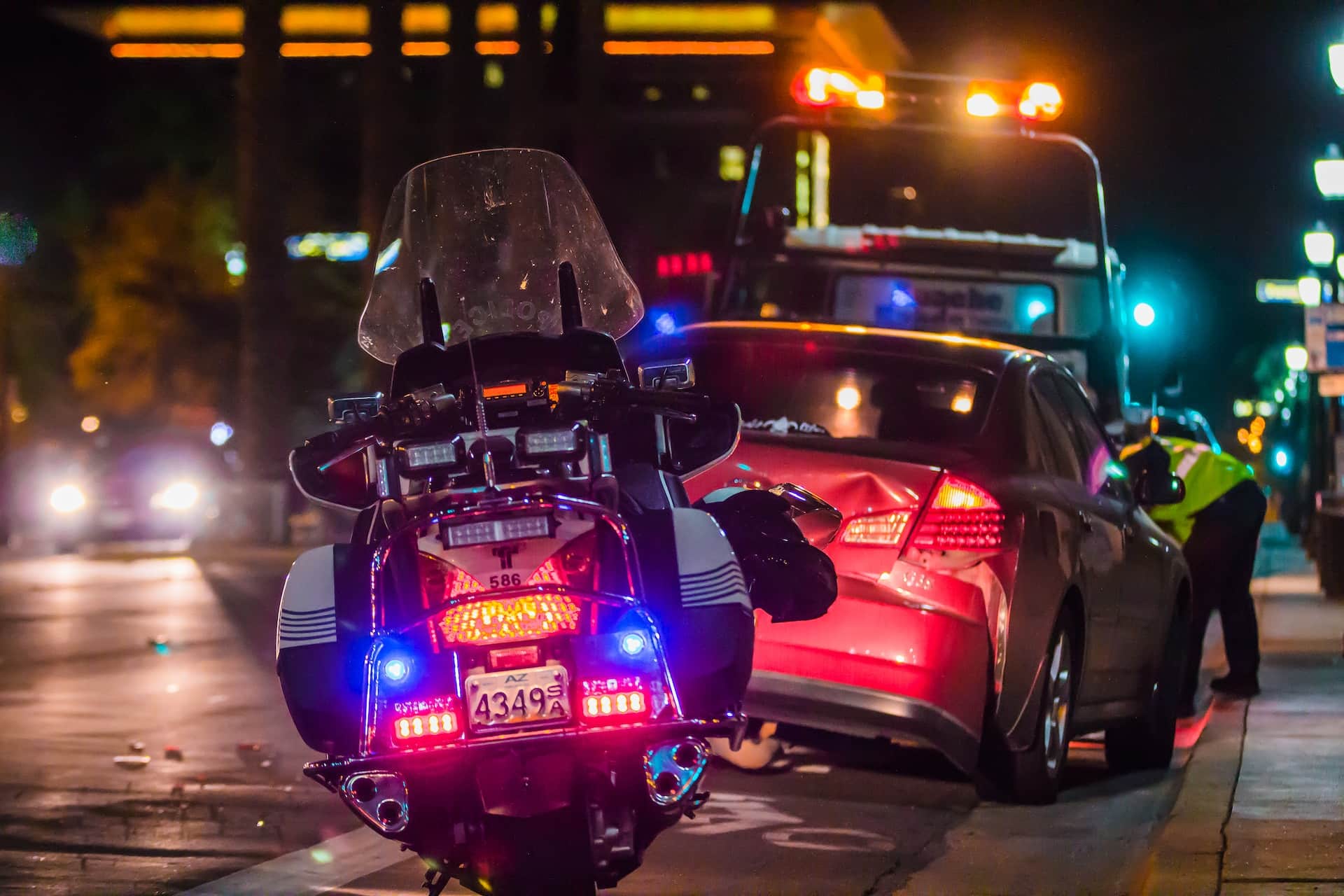 a police motorcycle parked behind a car being towed