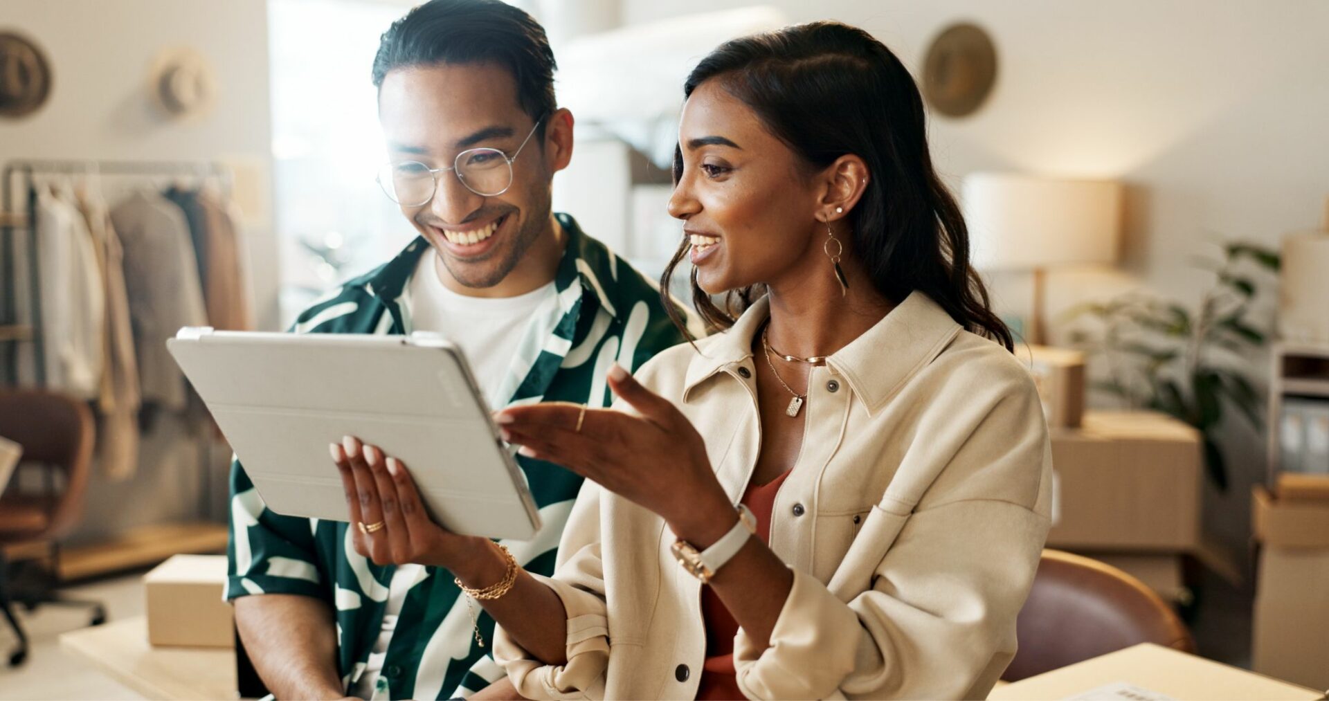 two people talking and looking at tablet