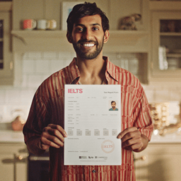 Man holding IELTS certificate TRF