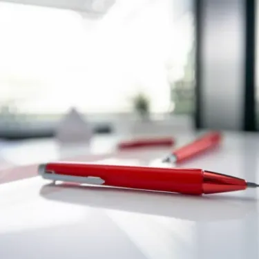 Red pen on a white desk