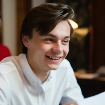 Man wearing white shirt reading