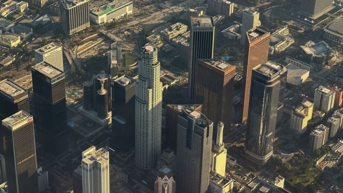 An aerial image taken on July 3, 2024 shows the Los Angeles area skyline, 110 Freeway, and helipads on the rooftops of Downtown Los Angeles buildings in the financial district above Los Angeles, California.