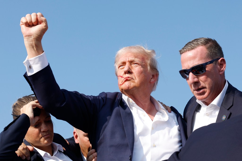 Republican presidential candidate former President Donald Trump is rushed offstage during a rally on July 13, 2024 in Butler, Pennsylvania.