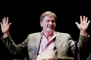 Author Michael Lewis with his hands in the air.