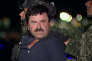 El Chapo surrounded by guards at night.