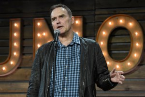 Norm Macdonald speaking into mic