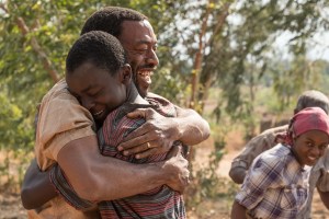 Chiwetel Ejiofor and Maxwell Simba hug in 'The Boy Who Harnessed the Wind'