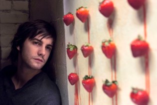 jim sturgess stares at a row of strawberries across the universe