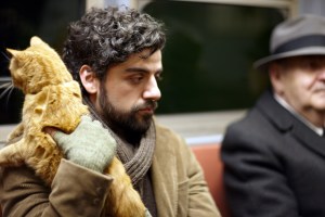 Oscar Isaac holds an orange cat in Inside Llewyn Davis