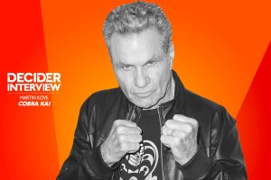 Martin Kove in black and white on a bright orange background