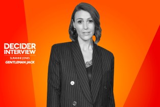 Suranne Jones in black and white on a bright orange background