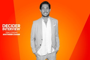 Craig Conover of Southern Charm in black and white on a bright orange background