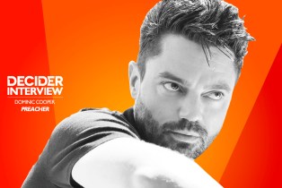 dominic cooper in black and white on a bright orange background