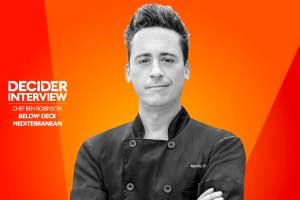 Chef Ben Robinson of Below Deck Med in black and white on a bright orange background